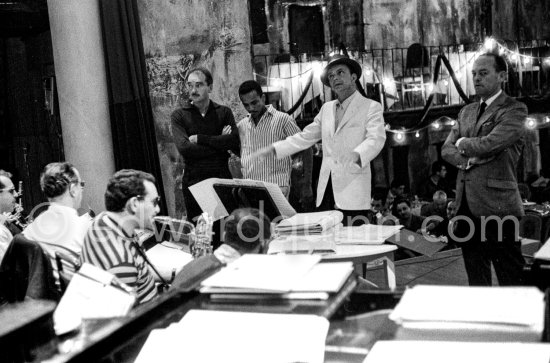 Frank Sinatra rehearsing with the orchestra at the Sporting d’Eté. Princess Grace, who was president of the Monégasque Red Cross, persuaded Sinatra to come back to Europe to sing at a gala in aid of refugee children. Monte Carlo 1958. - Photo by Edward Quinn