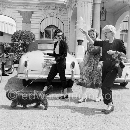 Soraya, Queen Consort and second wife of the Shah of Persia, with her mother and the secretary (from left) before leaving for Teheran with 48 suitcases. In front of the Carlton Hotel 1953. Car: 1949-51 Hudson Brougham convertible - Photo by Edward Quinn