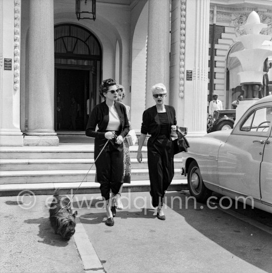 Soraya, Queen Consort and second wife of the Shah of Persia, with her mother and the secretary (from left) before leaving for Teheran with 48 suitcases. In front of the Carlton Hotel, Cannes 1953. - Photo by Edward Quinn