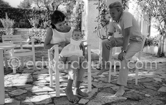 The Earl of Suffolk and his wife with their baby. Antibes 1961. - Photo by Edward Quinn