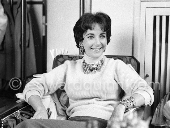 Attended by Cartier jewellers Liz Taylor tries on a beautiful diamond necklace with matching earrings she spotted while window-shopping in Monte Carlo with her third husband Mike Todd. At $500,000, the necklace was beyond Todd’s budget, but the earrings were her consolation prize. Monte Carlo 1958. - Photo by Edward Quinn