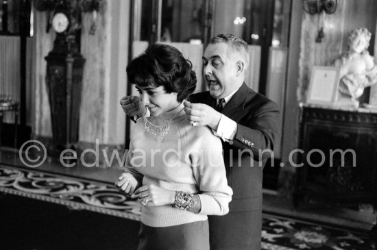 Attended by Cartier jewellers Liz Taylor tries on a beautiful diamond necklace with matching earrings she spotted while window-shopping in Monte Carlo with her third husband Mike Todd. At $500,000, the necklace was beyond Todd’s budget, but the earrings were her consolation prize. Monte Carlo 1958. - Photo by Edward Quinn