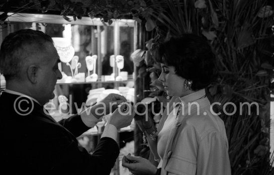 Attended by Cartier jewellers Liz Taylor tries on a beautiful diamond necklace with matching earrings she spotted while window-shopping in Monte Carlo with her third husband Mike Todd. At $500,000, the necklace was beyond Todd’s budget, but the earrings were her consolation prize. Monte Carlo 1958. - Photo by Edward Quinn