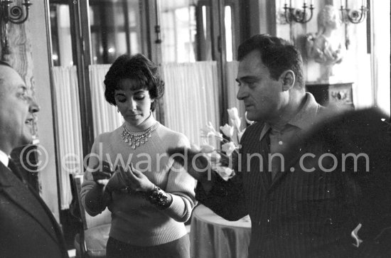 Attended by Cartier jewellers Liz Taylor tries on a beautiful diamond necklace with matching earrings she spotted while window-shopping in Monte Carlo with her third husband Mike Todd. At $500,000, the necklace was beyond Todd’s budget, but the earrings were her consolation prize. Monte Carlo 1958. - Photo by Edward Quinn