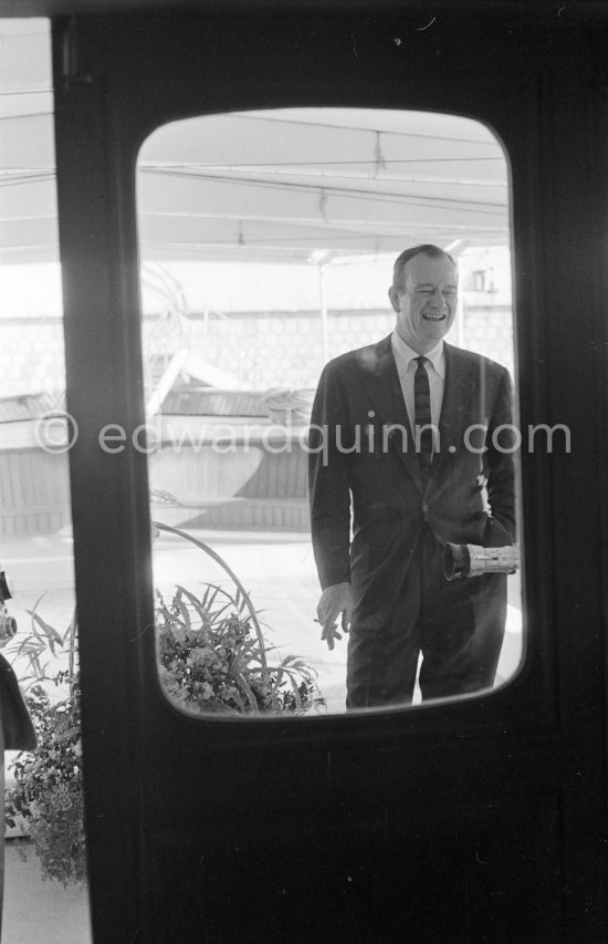 John Wayne on board Onassis\' yacht Christina. Monaco harbor 1955. - Photo by Edward Quinn