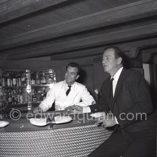 John Wayne on board Onassis' yacht Christina. Monaco harbor 1955. - Photo by Edward Quinn
