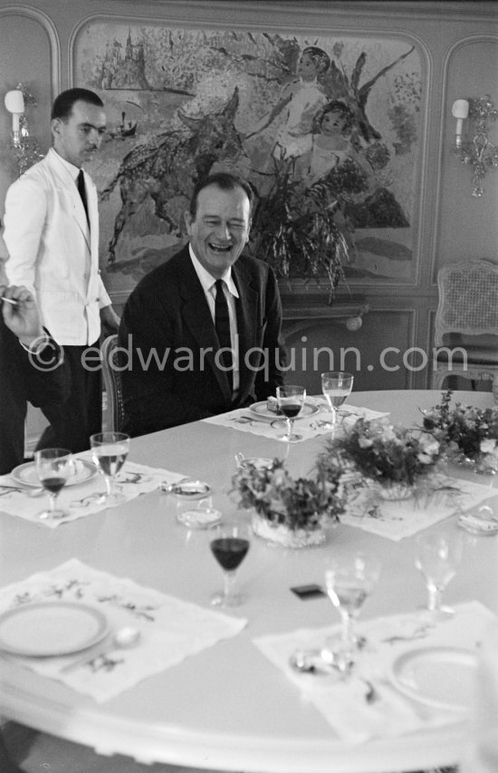 John Wayne on board Onassis' yacht Christina. Monaco harbor 1955. - Photo by Edward Quinn
