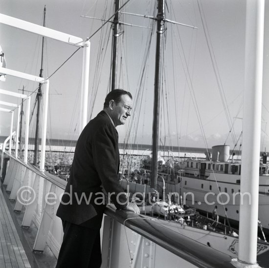 John Wayne on board Onassis\' yacht Christina. Monaco harbor 1955. - Photo by Edward Quinn