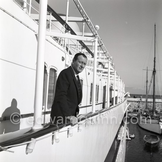John Wayne on board Onassis' yacht Christina. Monaco harbor 1955. - Photo by Edward Quinn