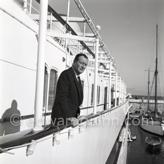 John Wayne on board Onassis\' yacht Christina. Monaco harbor 1955. - Photo by Edward Quinn