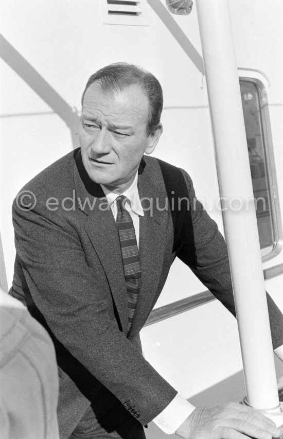 John Wayne on board Onassis' yacht Christina. Monaco harbor 1955. - Photo by Edward Quinn