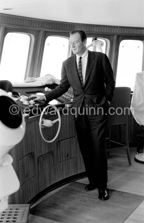 John Wayne on board Onassis' yacht Christina. Monaco harbor 1957. - Photo by Edward Quinn