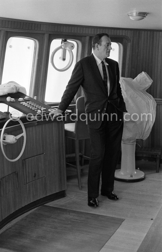John Wayne on board Onassis' yacht Christina. Monaco harbor 1955. - Photo by Edward Quinn