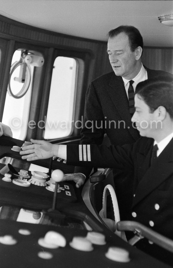 John Wayne on board Onassis' yacht Christina. Monaco harbor 1955. - Photo by Edward Quinn