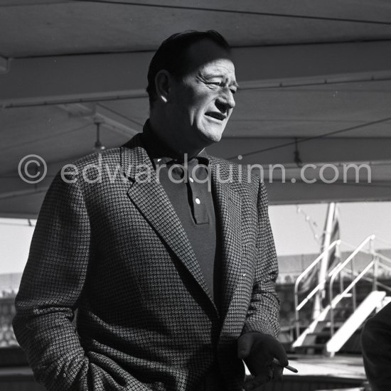 John Wayne on board Onassis' yacht Christina. Monaco harbor 1955. - Photo by Edward Quinn