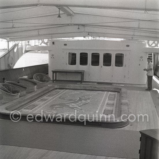 The mosaic swimming pool which drained and rose to deck level to create a dance floor on board Onassis\' yacht Christina. Monaco harbor 1955. - Photo by Edward Quinn