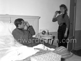 Brigitte Bardot being photographed by her husband Roger Vadim in their room at the Hotel Negresco. With a portable radio. Nice 1955. - Photo by Edward Quinn