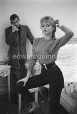 Brigitte Bardot being photographed by her husband Roger Vadim in their room at the Hotel Negresco. With a portable radio. Nice 1955. - Photo by Edward Quinn