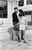 Georges Simenon with his poodle Mister and Charlie Chaplin's son Michael at his Villa Golden Gate. Cannes 1955. - Photo by Edward Quinn