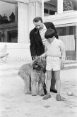 Georges Simenon with his poodle Mister and Charlie Chaplin's son Michael at his villa Golden Gate. Cannes 1955. - Photo by Edward Quinn