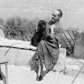 René Clair with his poodle on the terrace of his mansion. Sainte-Maxime 1953. - Photo by Edward Quinn