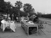 The jury of the Concours d’élégance. The Begum with white hat at the table. Cannes 1954. - Photo by Edward Quinn
