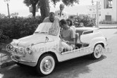 Gary Cooper's long legs fit well into the beach buggy of English millionaire James Hanson. Eden Roc, Cap d’Antibes 1959. Car: 1959 Fiat 600 Jolly. - Photo by Edward Quinn