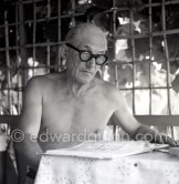 Le Corbusier (Charles-Édouard Jeanneret) at the small restaurant L'Etoile de Mer next to his vacation cabin Le Cabanon. Roquebrune-Cap-Martin 1953. - Photo by Edward Quinn