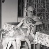 Le Corbusier (Charles-Édouard Jeanneret) with his dog at the small restaurant L'Etoile de Mer attached to his vacation cabin Le Cabanon. Roquebrune-Cap-Martin 1953. - Photo by Edward Quinn