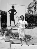 Dorothy Dandrige in front of a poster announcing the showing of her film "Carmen Jones" at the Film Festival after a great deal of controversy with the French copyright holders of the music. Cannes 1955. - Photo by Edward Quinn