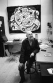 Jean Dubuffet with his painting "Pendule IV (Flamboiement de l'heure)" at his studio in Vence 1966. - Photo by Edward Quinn