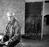 Max Ernst. Behind him the painting "Tremblement de terre printanier". Seillans 1966. - Photo by Edward Quinn