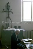 Max Ernst working on a collage at his studio. Seillans 1975. - Photo by Edward Quinn
