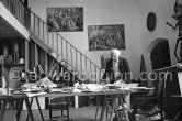 Max Ernst working on a collage at his studio. Seillans 1975. - Photo by Edward Quinn