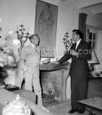 Rock Hudson at a cocktail party given by Jacques Fath (left) at his home "Moulin de Joko". Cannes 1954. - Photo by Edward Quinn