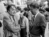 Federico Fellini in a conversation. Cannes Film Festival 1957. - Photo by Edward Quinn