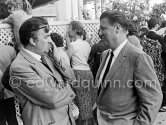 Federico Fellini in a conversation. Cannes Film Festival 1957. - Photo by Edward Quinn