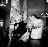 Zsa Zsa Gabor with Earl Blackwell, the head of "Celebrity Service", in the lobby of the Carlton Hotel, during the Cannes Film Festival 1955. - Photo by Edward Quinn