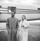 Zsa Zsa Gabor and Porfirio Rubirosa in front of the private plane of Porfirio Rubirosa, a converted North American B-25 Mitchell, at Cannes Airport in 1954. North American B-25 Mitchell B-25H-1NA 43-4432 (N10V). See https://bit.ly/2XS08rs. Was as "Berlin Express" in the 1970 movie Catch-22. Today at Eagle Hangar, EAA Aviation Museum, Oshkosh. - Photo by Edward Quinn