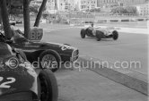 Stranded Vanwalls of Stirling Moss' (28) and Stuart Lewis-Evans' (32). Cliff Allison, (24), passes in Lotus 12. Monaco Grand Prix 1958. - Photo by Edward Quinn
