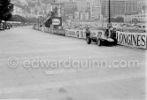 Innes Ireland pushes his N° 22 Lotus 18 uphill and right around the twisting Monaco circuit so that he can finish the race. His effort was repaid when he got 9th place and one point for the world championship. Monaco Grand Prix 1960. - Photo by Edward Quinn
