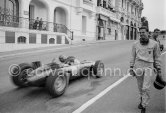 Jim Clark walking back to the pits (broken clutch). Graham Hill, (10) B.R.M. P57 passing. Monaco Grand Prix 1962.Monaco Grand Prix 1962. - Photo by Edward Quinn