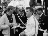 Steve McQueen, signing autographs for policemen, and Ronnie Bucknum (USA, Honda 272). Monaco GP 1965. - Photo by Edward Quinn