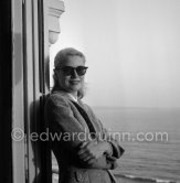 Grace Kelly on the balcony of her room in the Carlton Hotel. Cannes Film Festival 1955. - Photo by Edward Quinn