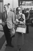 Grace Kelly with the original Kelly Bag arriving at Cannes station 1955. With her is Rupert Allan. - Photo by Edward Quinn