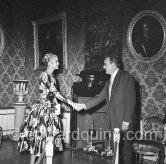 Grace Kelly Grace Kelly (later to become Princess Grace) meets Prince Rainier at the Royal Palace. The historic moment of the first formal handshake. Their smile seems to show an instant contact and already a mutual esteem. Monaco 1955. - Photo by Edward Quinn