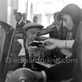 Gene Kelly, signing autographs. The American dancer, singer and choreographer was said to have danced more miles than walked. Cannes 1955. - Photo by Edward Quinn