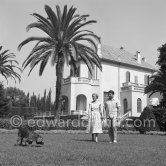 Prince Sadruddin ("Sadri") Khan and his mother Princess Andrée, third wife of Aga Khan, with their attentive spaniel at their home in Cap d’Antibes in 1954. - Photo by Edward Quinn
