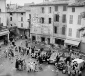 Locals waiting for the bridal couple Sir Alex Korda and Miss Alexandra Boycun in front of the town hall of Vence 1953. Cars: 1939-49 Austin 10; 1948-56 Peugeot 203; 1949-52 Renault 4CV; 1946-49 Simca 8 and a delivery vehicle (from left) - Photo by Edward Quinn