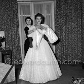 Sophia Loren in her Carlton Hotel room during the Cannes Film Festival wearing an evening gown designed by Emilio Schuberth, 27 April 1955. - Photo by Edward Quinn